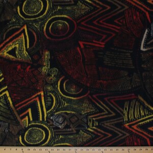 May include: Abstract fabric with a black background and a colorful geometric pattern. The pattern features yellow, red, orange, and green shapes. The fabric has a textured surface.