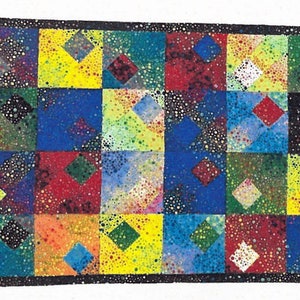 May include: A colorful quilt with a geometric pattern of squares and diamonds. The quilt is made of a variety of fabrics, including blue, green, yellow, red, and black. The quilt is decorated with small white dots.