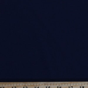 May include: A close-up of a dark blue fabric swatch with a wooden ruler measuring 18 inches.
