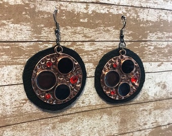 Black leather accented with  copper and red stones