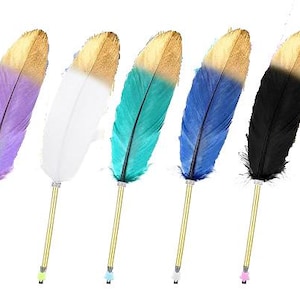 May include: Five pens with gold-toned metal barrels and decorative feathers attached to the top. The feathers are colored purple, white, teal, blue, and black, each featuring a gold-dipped tip. Each pen has a small star-shaped cap at the base.
