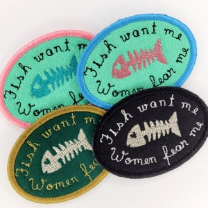 May include: Four embroidered patches with a fish skeleton and the text "Fish want me women fear me". The patches are in different colours: green, black, teal, and pink.