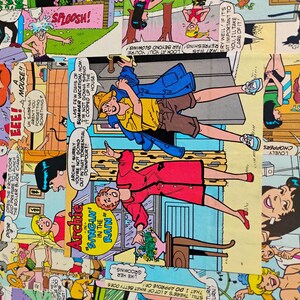May include: A colorful comic book panel fabric featuring various scenes and characters. The panels display speech bubbles with text, and the artwork includes figures in various poses and settings. The overall design is vibrant and eye-catching.