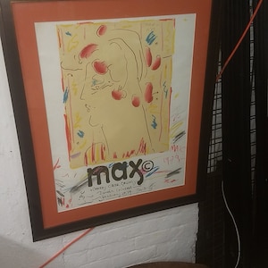 May include: A framed poster with a colorful abstract painting of a person's head. The poster is titled "max" and includes the text "Cherry Creek Gallery, Denver, Colorado, February 3-29, 1979".