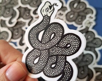 May include: A black and white sticker of a snake with a skull for a head. The snake is coiled up and has a dripping effect coming from its mouth.