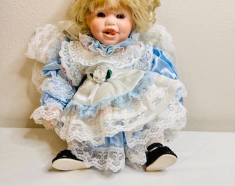 Vintage Porcelain Doll in White Blue Floral Dress, Smiling
