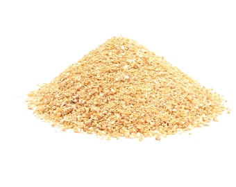 May include: A pile of light brown, granular material, possibly a food product or ingredient, against a white background. The texture appears coarse and uneven, with small, irregular particles forming a mound.