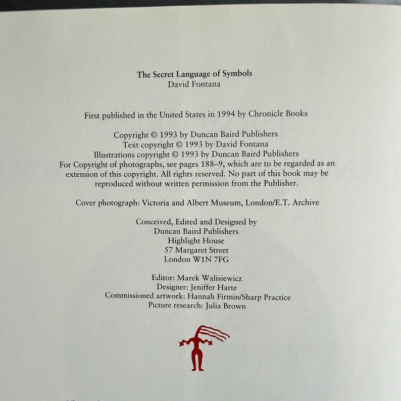 May include: A page from "The Secret Language of Symbols" by David Fontana, published in 1994. The text includes copyright information, publisher details, and credits for the cover photograph, design, and artwork. A red graphic is at the bottom.