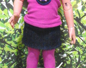 May include: A doll wearing a pink shirt with a blue star, a dark blue denim skirt, pink leggings, and white sneakers with black trim.