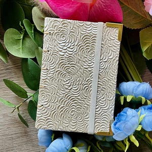Handbound Coptic Sketchbook – 3.375x4.75" – 56 Pages – Mixed Pastel Papers – Embossed Cover, Gold Corners, Elastic Closure – Artist Gift