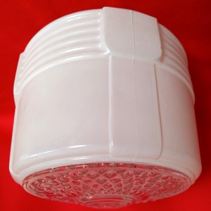 May include: White glass ceiling light fixture with a textured, clear glass bottom.
