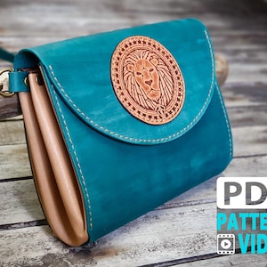 May include: Teal leather crossbody bag with a brown leather flap and a lion head design on the front. The bag has a strap and a metal clasp. PDF PATTERN VIDEO.
