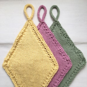 May include: Three knitted dishcloths in yellow, pink, and green. Each dishcloth has a loop handle and a diamond shape.