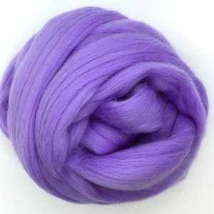 May include: A ball of light purple wool roving, a type of fiber used for felting and spinning.
