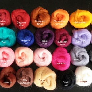 May include: A collection of 36 small balls of wool in various colors, including red, green, blue, purple, pink, orange, yellow, brown, black, white, and gray. Each ball is labeled with a color name.