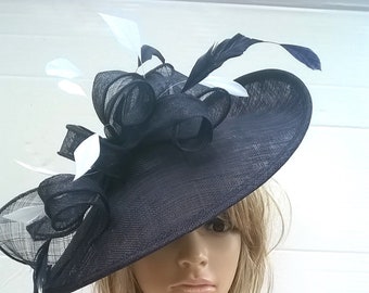 Navy Blue Hatinator with white or ivory Sinamay and feathers on a Headband.