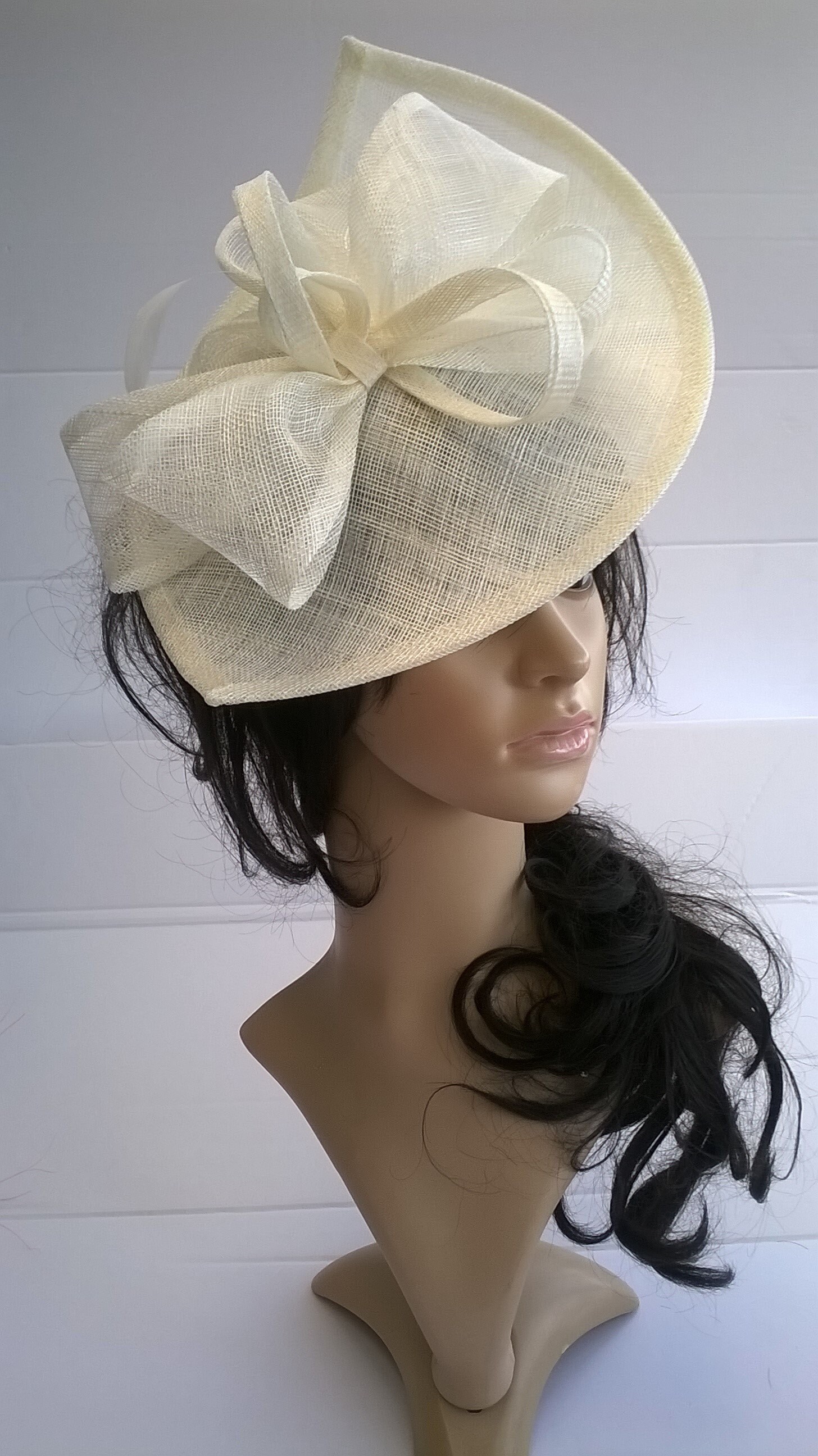 Ivory Fascinator ..styled with Bow ,swirls & feathers on a headband..navy