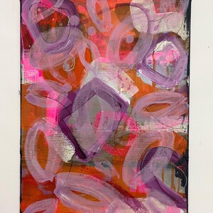 May include: Abstract painting with a mix of pink, purple, orange, and white paint. The painting has a textured surface and a black background.