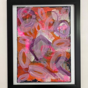 May include: Abstract painting with a mix of pink, purple, orange, and black paint. The painting features a variety of shapes, including circles, ovals, and squares.
