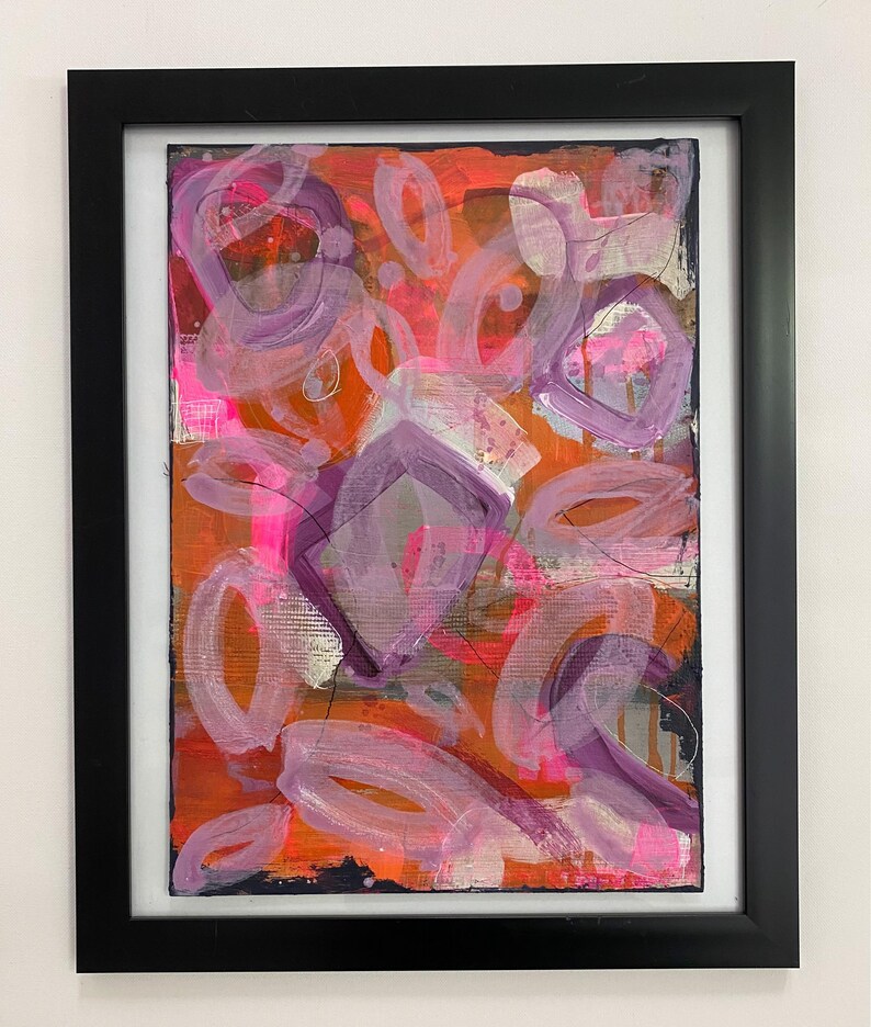 May include: Abstract painting with a mix of pink, purple, orange, and black paint. The painting features a variety of shapes, including circles, ovals, and squares.