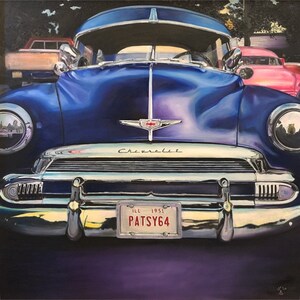 May include: A close-up of a blue 1951 Chevrolet with a chrome bumper and a license plate that reads "PATSY64".