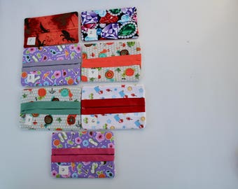May include: Ten tissue holders with different patterns. The holders are numbered 1 through 7. The patterns include a red and black floral design, a purple and green jewel design, a purple and pink floral design, a white and orange floral design, a white and green floral design, a white and red floral design, and a purple and pink floral design.