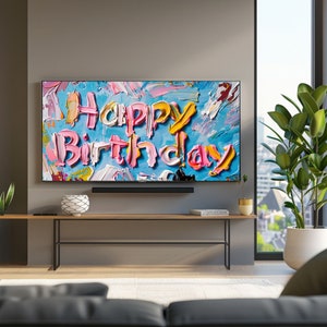 May include: A television screen displaying a colourful abstract painting with the words "Happy Birthday" in large, stylised letters.