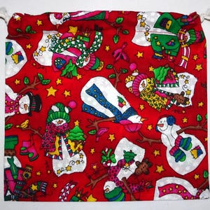 May include: Red fabric with a white background featuring a repeating pattern of snowmen, stars, and other winter-themed designs. The fabric is perfect for crafting projects like gift bags, pouches, or other festive decorations.