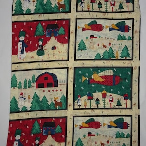 May include: A beige fabric drawstring bag with a Christmas theme. The bag features a repeating pattern of snowmen, angels, houses, and trees. The background is a light beige with a red and green plaid pattern.