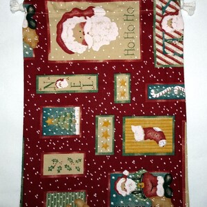 May include: Red fabric gift bag with a Christmas theme. The bag features a repeating pattern of Santa Claus, candy canes, Christmas trees, and the words "Ho Ho Ho".