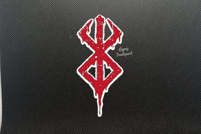 May include: Red and white distressed sticker of the "Berserk" manga series logo, a stylized "B" with dripping blood, on a black background. The text "Gypsy Tradepost" is visible in the bottom right corner.
