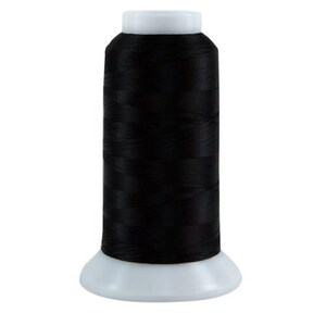 May include: A spool of black thread for sewing or embroidery.