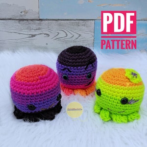 May include: Three crocheted octopus amigurumi toys. The octopus on the left is black, pink, and orange. The octopus in the middle is purple and black. The octopus on the right is green and orange. The text "PDF PATTERN" is in the upper right corner of the image.