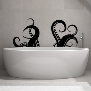 May include: A white bathtub with two black octopus silhouettes on the wall behind it. The octopus silhouettes are in a stylised design with rounded edges.