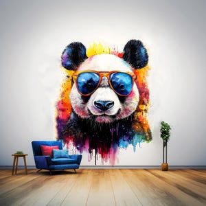 May include: A vibrant watercolour painting of a panda wearing orange-framed sunglasses. The panda's fur is black and white, with colourful splashes around its head. The image is on a white wall above a blue armchair and wooden floor.