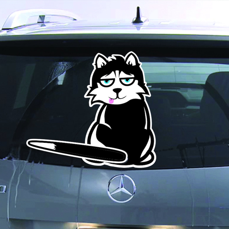 May include: A black and white cartoon husky dog sticker with a pink tongue sticking out. The dog is sitting on its hind legs with its tail sticking out behind it. The sticker is on the back window of a car.