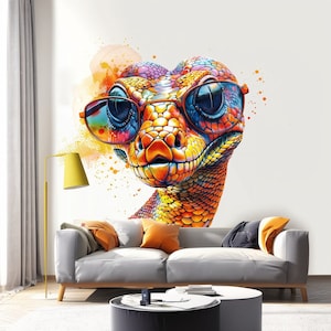 May include: A colorful snake with a bright orange, yellow, and blue pattern wears sunglasses. The snake's head is facing forward and the snake is looking directly at the viewer. The snake is on a white background with watercolor splatters.