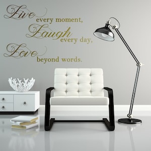 May include: Gold vinyl wall decal with the words "Live every moment, Laugh every day, Love beyond words."