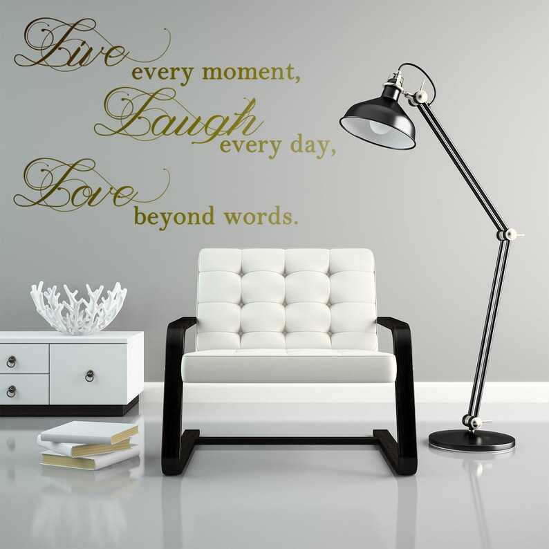 May include: Gold vinyl wall decal with the words "Live every moment, Laugh every day, Love beyond words."