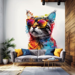 May include: A colorful abstract painting of a cat wearing sunglasses. The cat is looking to the right and has a white background. The painting is in a living room setting with a gray couch and a coffee table.
