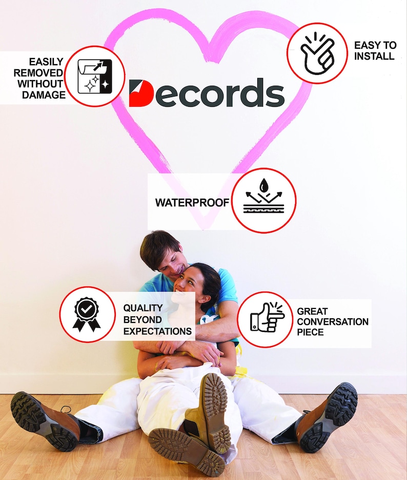 May include: A couple sits in front of a white wall with a pink heart painted on it. The heart has the word "Decords" written on it. There are several red circles with white icons and text inside them. The text includes "Easily Removed Without Damage", "Waterproof", "Easy to Install", "Quality Beyond Expectations", and "Great Conversation Piece".