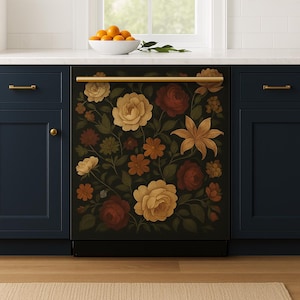 A navy kitchen features a dishwasher panel wrapped in a dark floral decal with detailed illustrations of vintage roses, lilies, and golden blooms, creating a warm, romantic focal point beneath a white countertop.