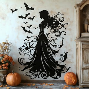 May include: Black silhouette wall decal of a woman in a flowing gown with intricate floral designs and bats flying around her.