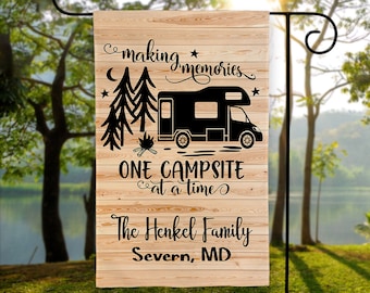 May include: A wooden sign with a black silhouette of a camper van, trees, and a campfire. The text reads "Making memories, One campsite at a time, The Henkel Family, Severn, MD".