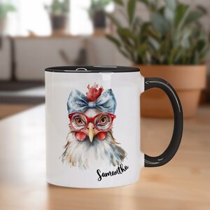 May include: White ceramic mug with a black rim and handle. The mug features a watercolor illustration of a chicken wearing red glasses and a blue bow. The text "Samantha" is printed in black below the illustration.