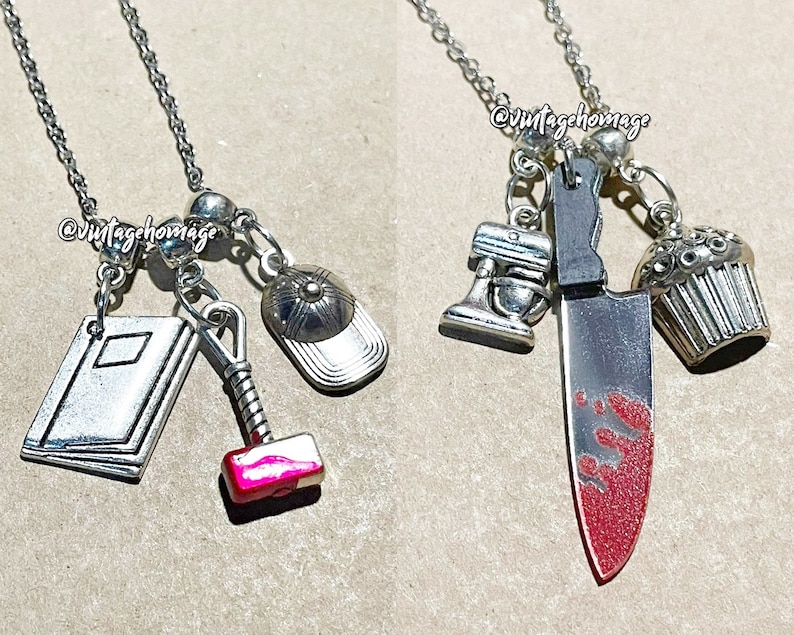 May include: Two silver necklaces with charms. One necklace has a book, a hammer, a baseball cap, and silver beads. The other necklace has a knife with red paint, a cupcake, a mixer, and silver beads. Both necklaces have the text "@vintagehomage" on the beads.