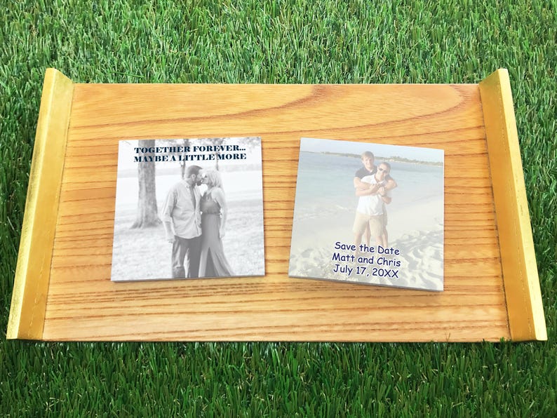 Custom photo save the date Post-it notes displayed on a wooden tray, featuring personalized images and wedding date text