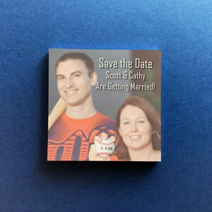 Custom save the date Post-it notes featuring a personalized photo and save the date with the wedding date below, shown on a blue background