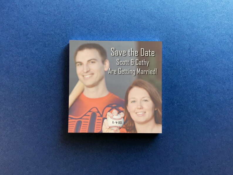 Custom save the date Post-it notes featuring a personalized photo and save the date with the wedding date below, shown on a blue background