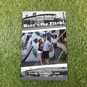 May include: A rectangular invitation card featuring a black and white photograph of a stadium, a couple standing in front of graffiti, and the text: Jessie Fuller & Scott Dunkin, Here's the Pitch!, Saturday, September 21, 20XX, 6:00pm.